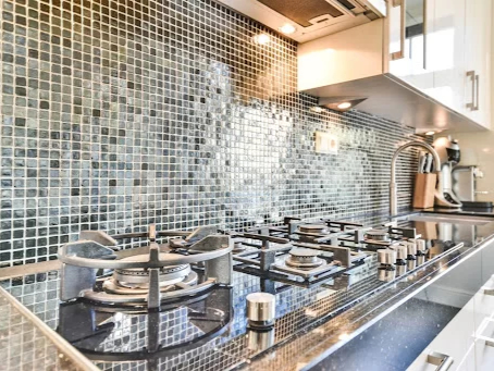 Mosaic tiles with metallic finishes in gold, bronze, and copper