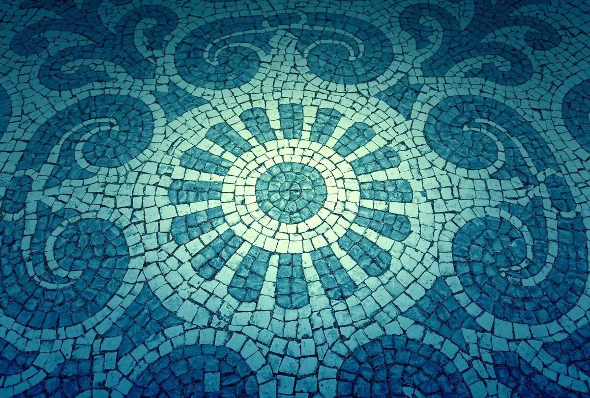 Decorative circular blue mosaic tile pattern used as a feature wall design element