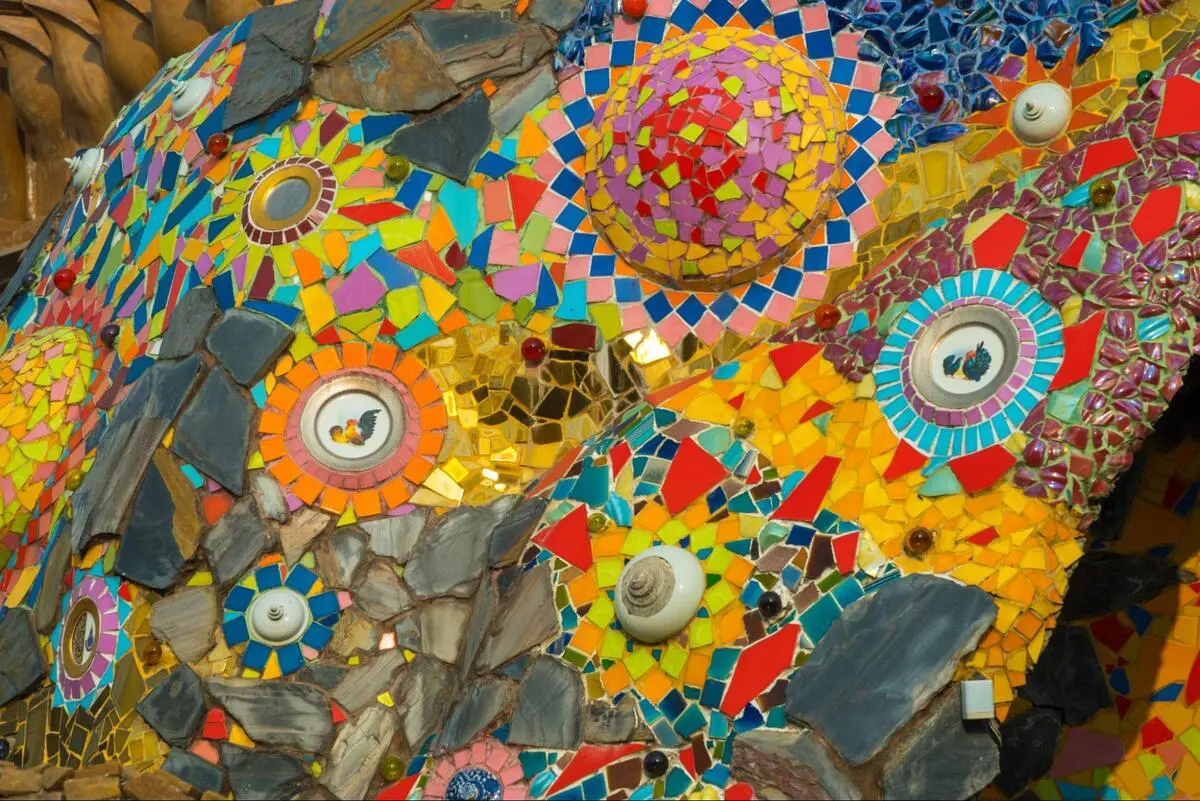 Vibrant colorful mosaic art made of small ceramic tile pieces in multiple colors and shapes