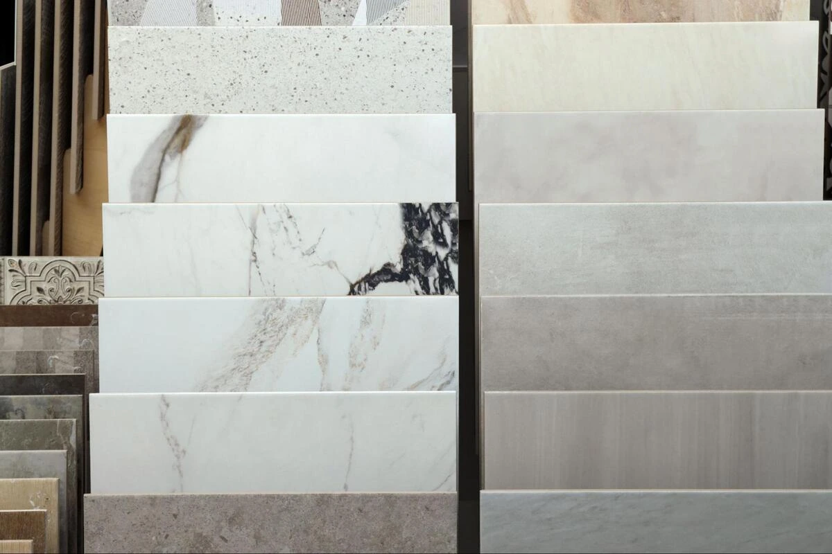 Multiple tile samples in different colours and finishes displayed on store shelving